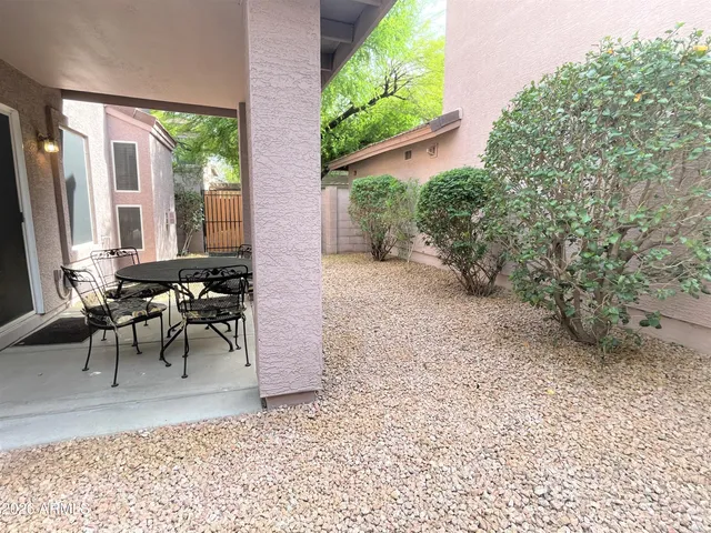 a backyard of a house with outdoor seating