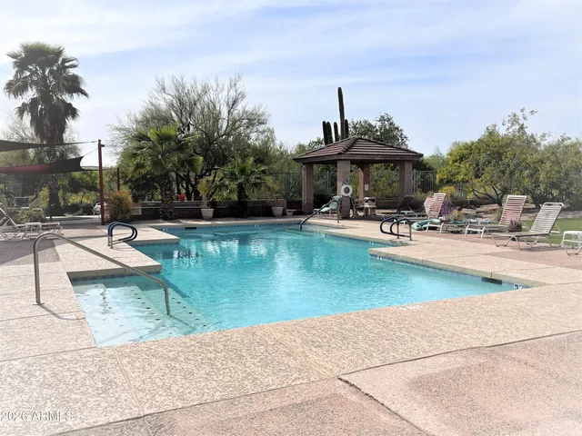 a view of a house with swimming pool and sitting area