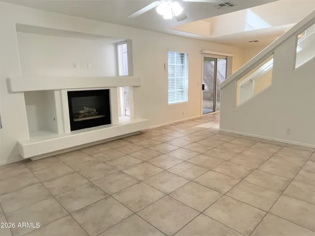a view of an empty room with glass door and a window
