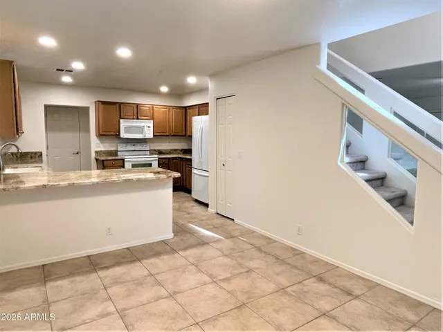 a kitchen with stainless steel appliances a refrigerator and a stove top oven