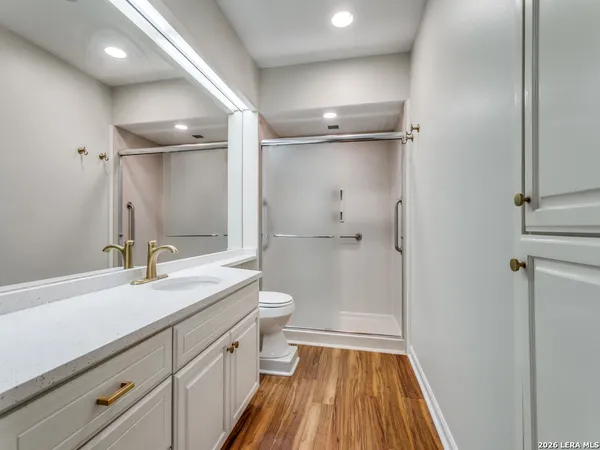 a bathroom with a sink a toilet and shower
