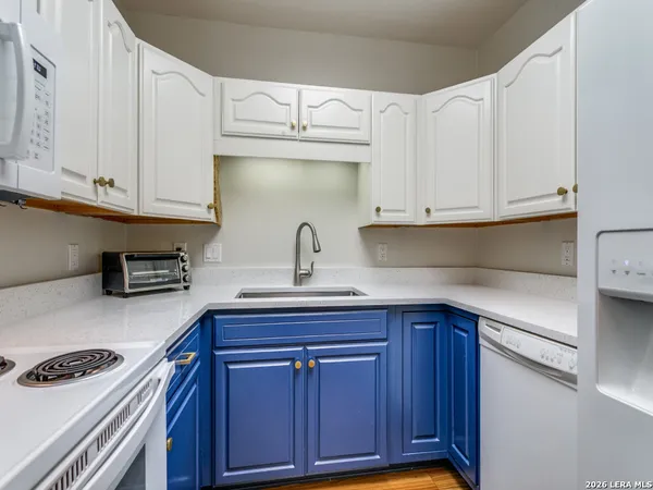 a kitchen with stainless steel appliances granite countertop a sink and cabinets
