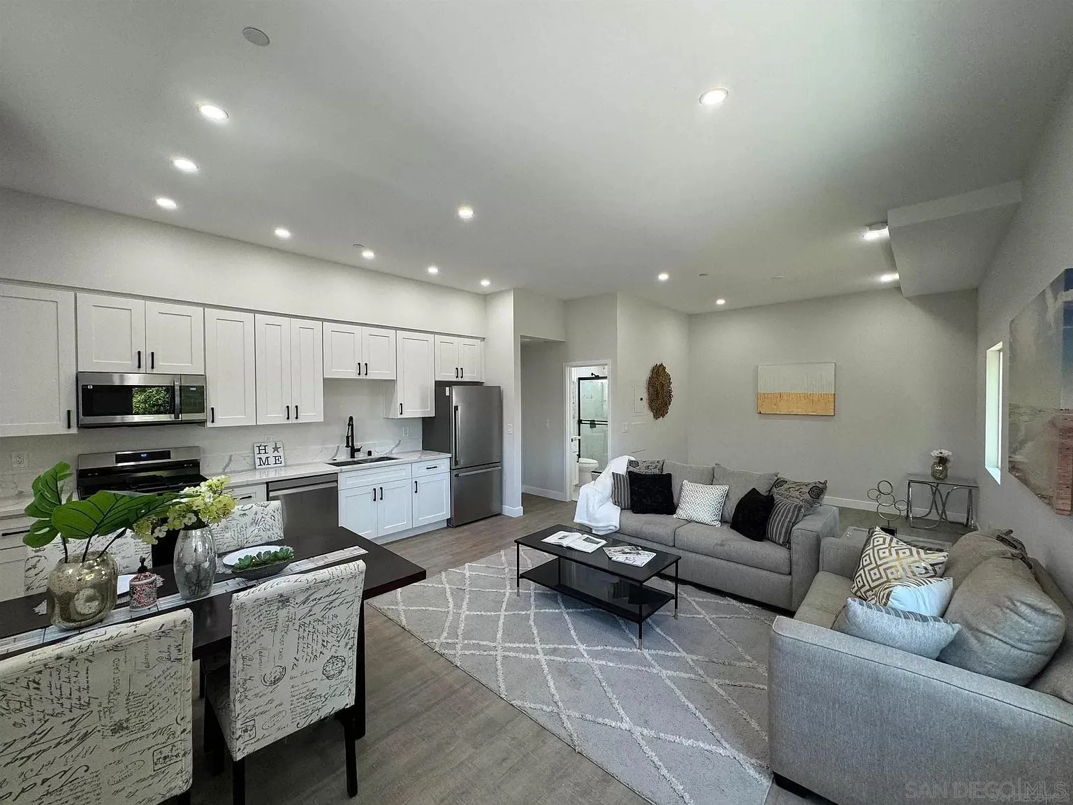 1064 11th Street, Unit 2 Imperial Beach, CA 91932 - Photo 2 of 10 a living room with furniture kitchen and a wooden floor