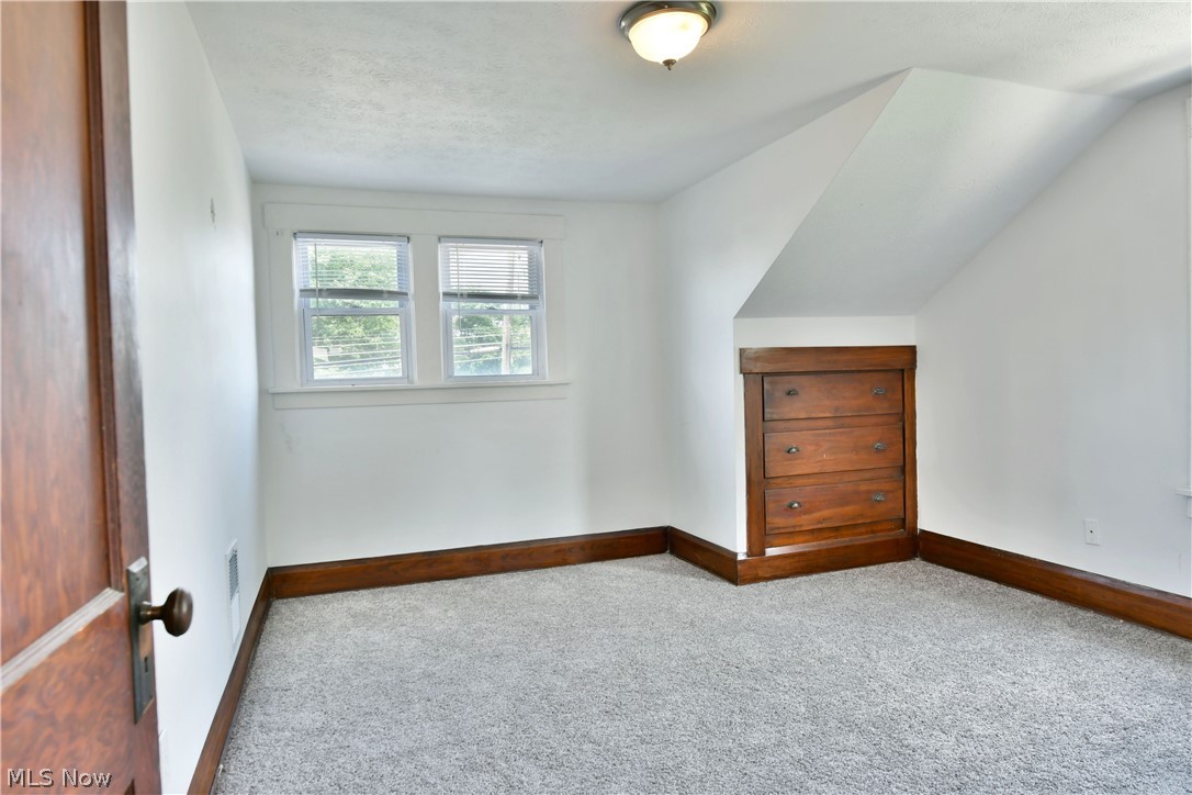 3617 South Main Street Mineral Ridge, OH 44440 - Photo 25 of 34 Bonus room featuring carpet flooring, a textured ceiling, and lofted ceiling