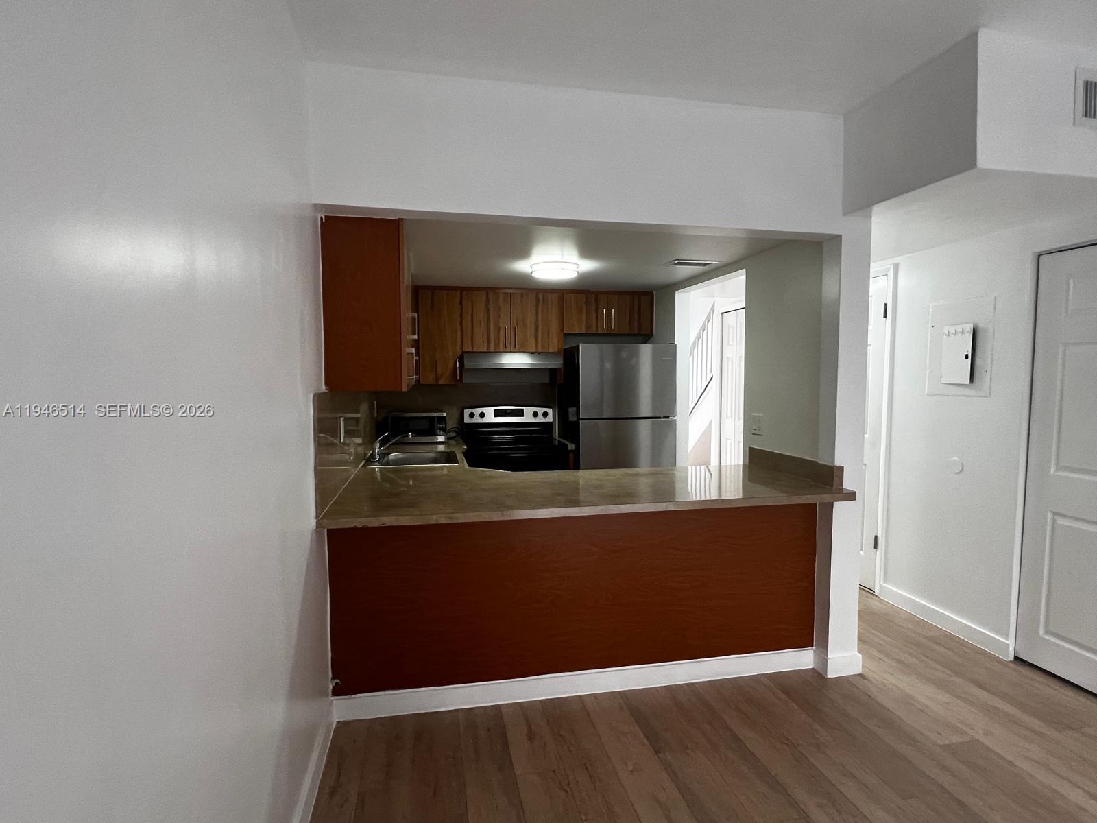 324 West 74th Place, Unit 6 Hialeah, FL 33014 - Photo 3 of 13 a view of room with wooden floor