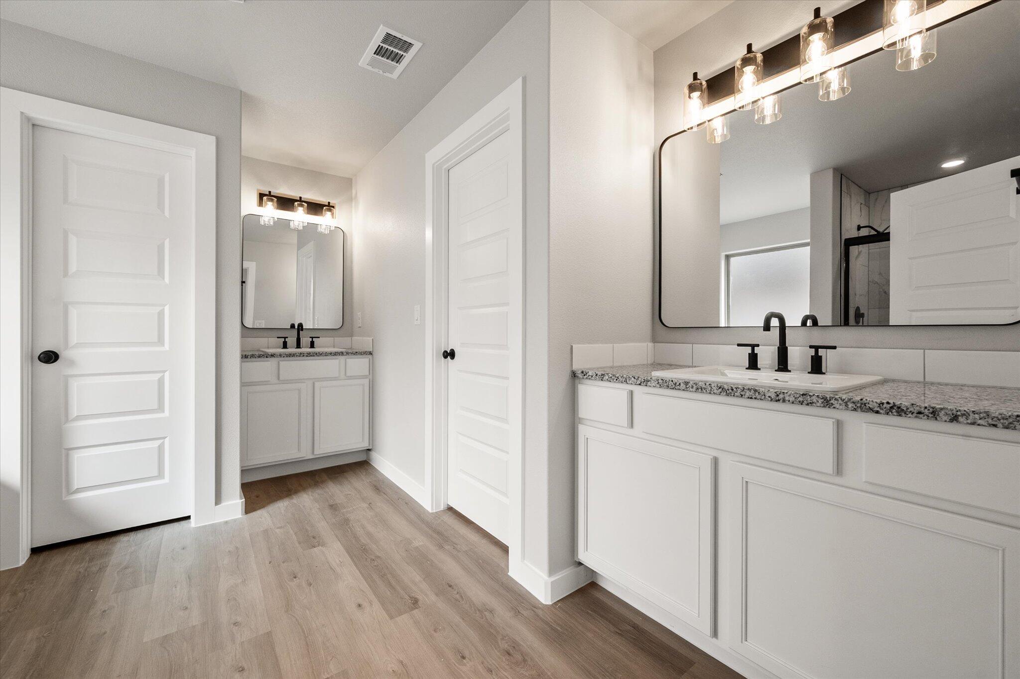 6825 54th Street Lubbock, TX 79407 - Photo 14 of 22 a bathroom with a sink and a mirror