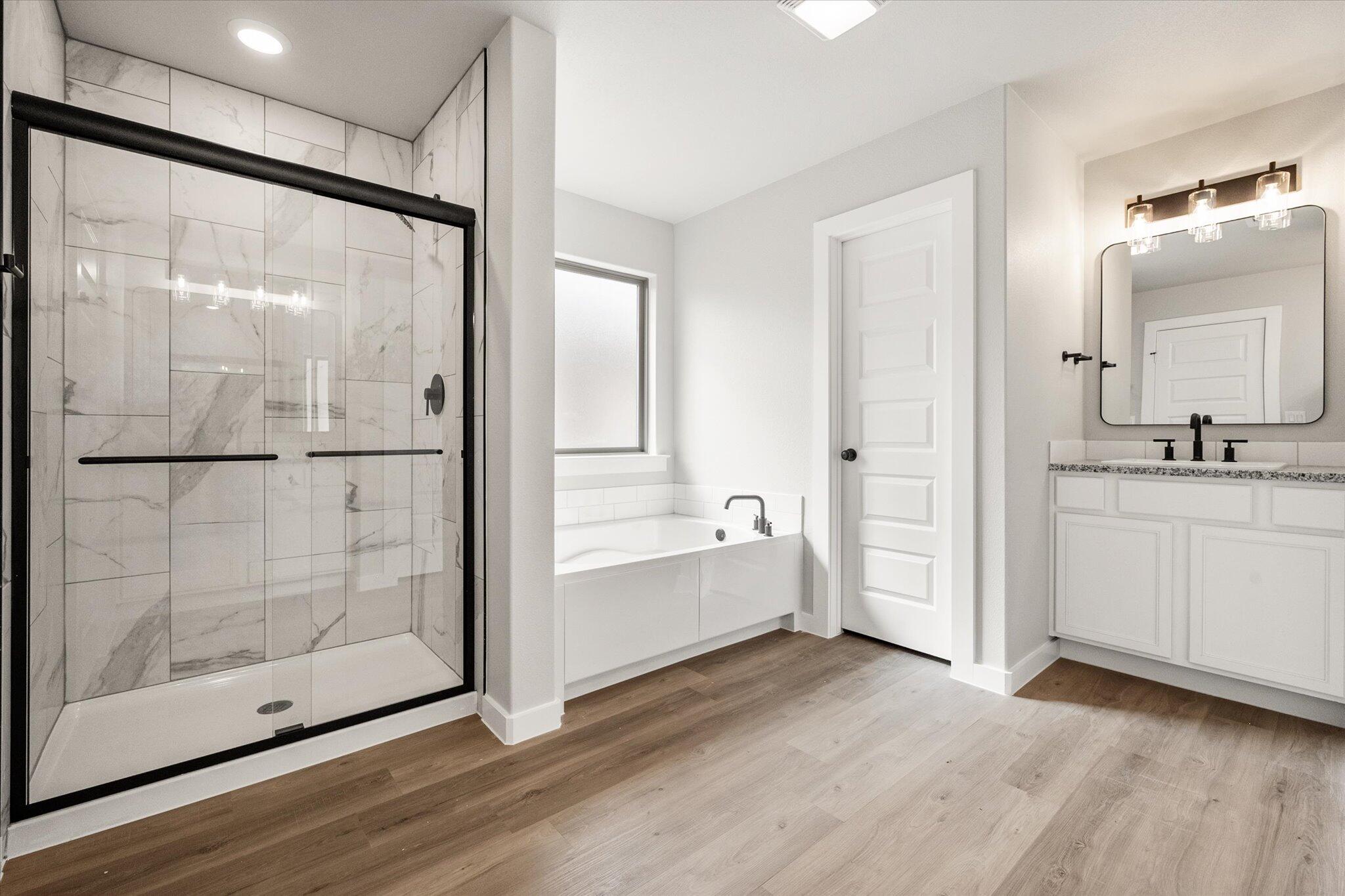 6825 54th Street Lubbock, TX 79407 - Photo 15 of 22 a bathroom with a glass shower door and a sink