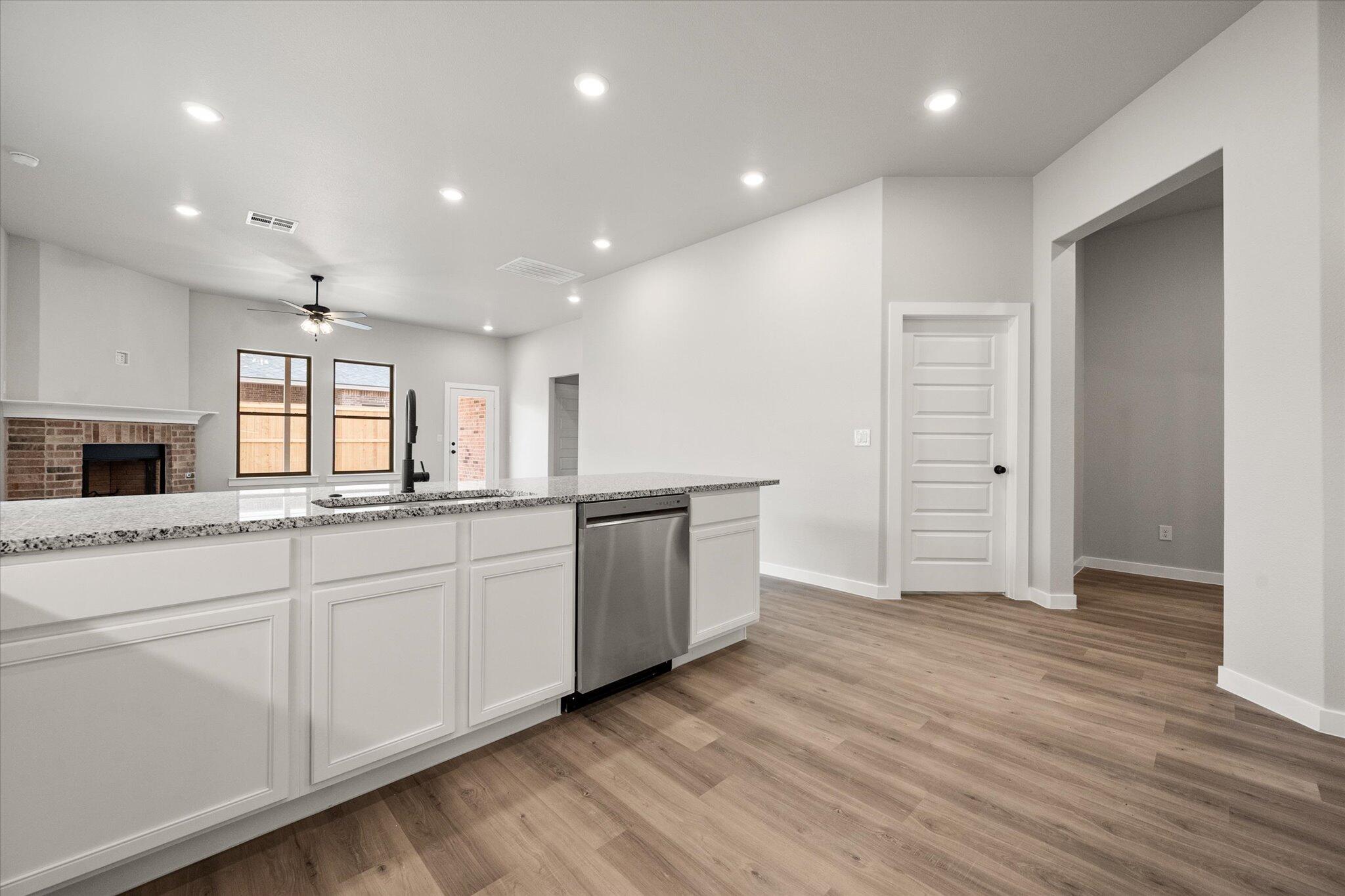 6825 54th Street Lubbock, TX 79407 - Photo 6 of 22 a large kitchen with lot of counter space and wooden floor
