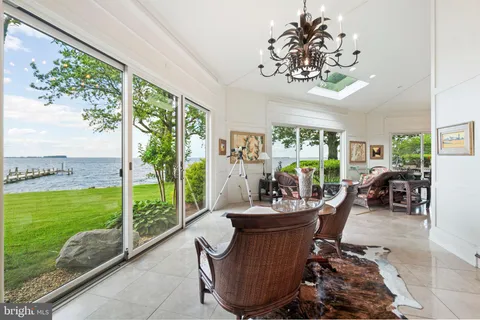 a large kitchen with stainless steel appliances kitchen island granite countertop a refrigerator and a stove top oven