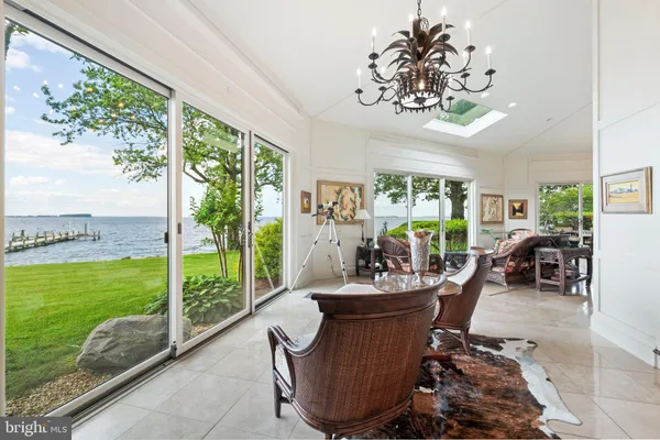 a large kitchen with stainless steel appliances kitchen island granite countertop a refrigerator and a stove top oven