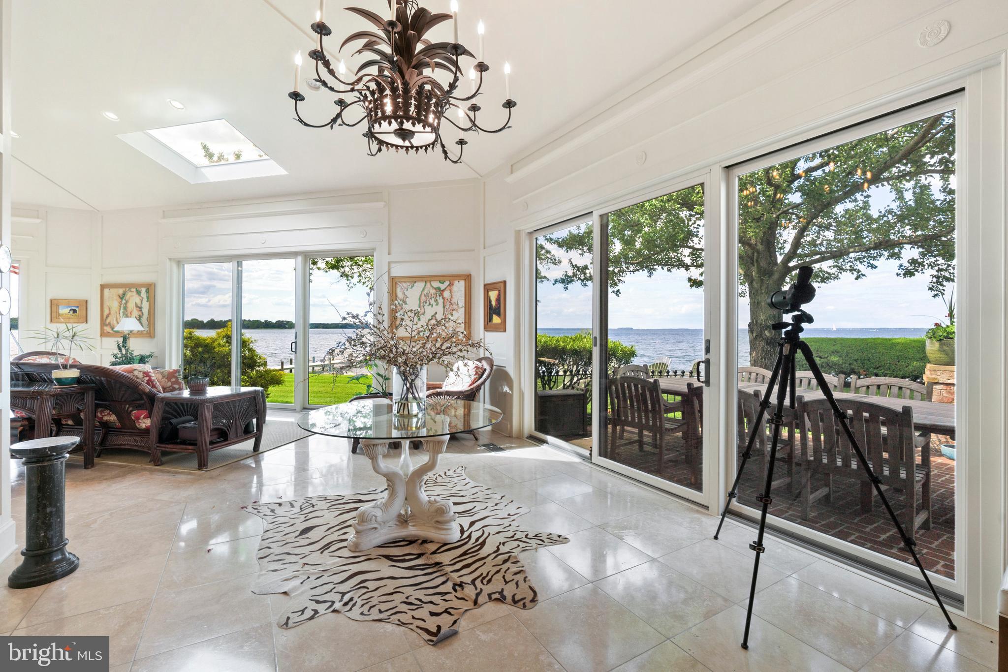 9791 Pintail Place St. Michaels, MD 21663 - Photo 13 of 80 a living room with patio furniture and a floor to ceiling window