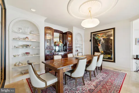 a living room with furniture and a book shelf
