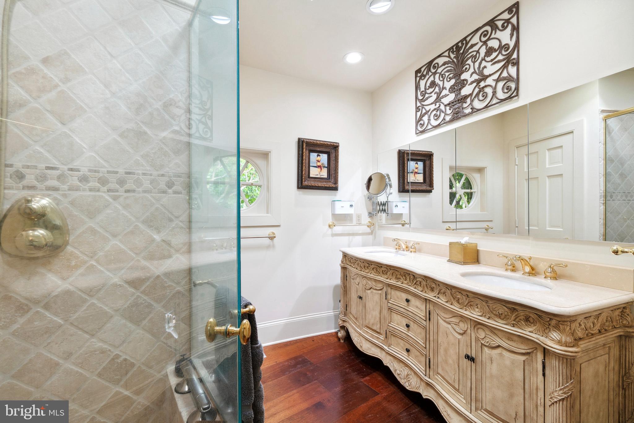 9791 Pintail Place St. Michaels, MD 21663 - Photo 25 of 80 a bathroom with a granite countertop sink a mirror and a shower