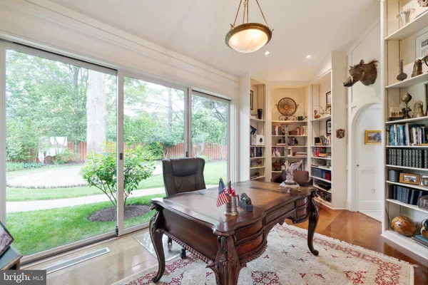a view of a hallway with wooden floor and closet area
