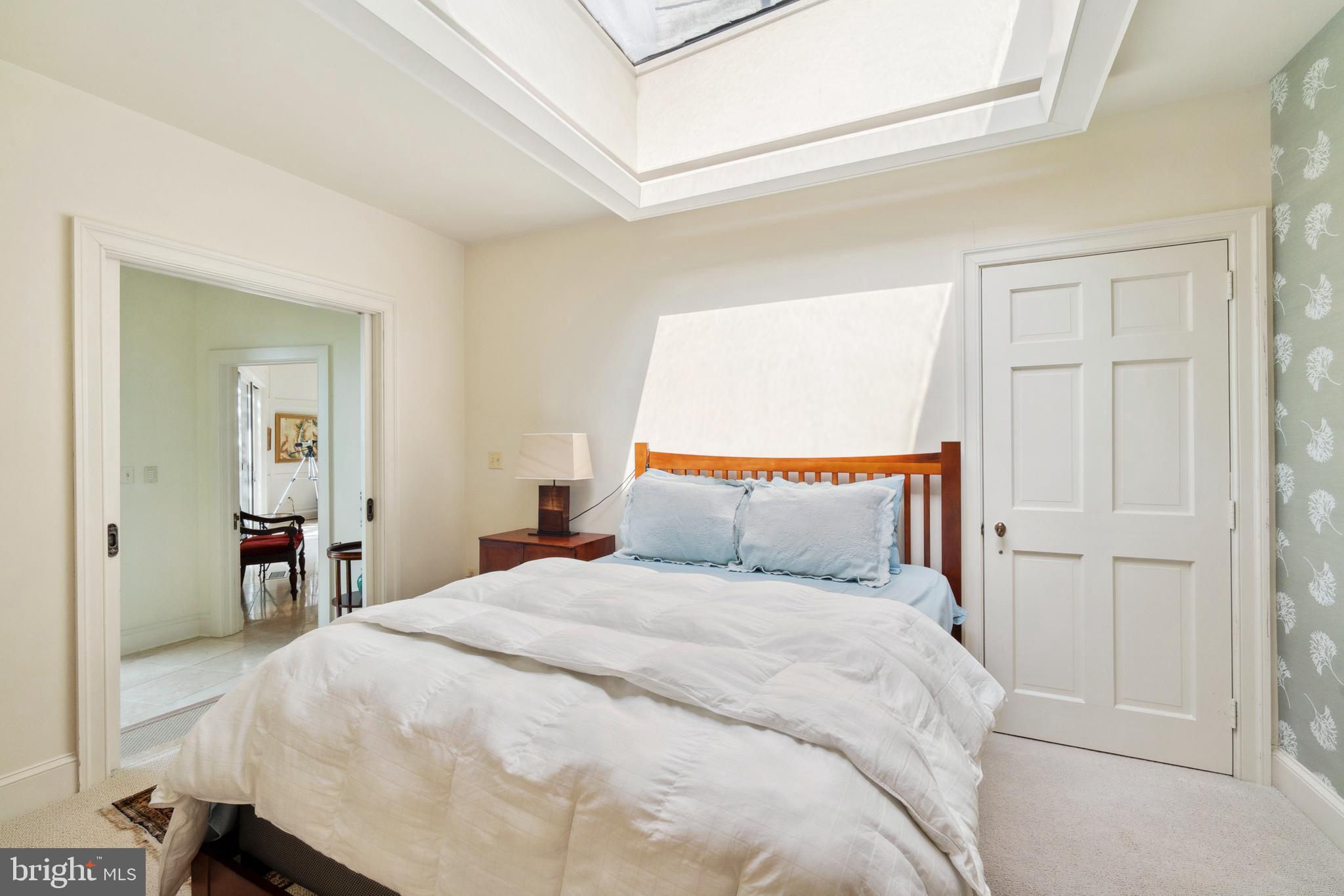 9791 Pintail Place St. Michaels, MD 21663 - Photo 31 of 80 a bedroom with a bed and a lamp