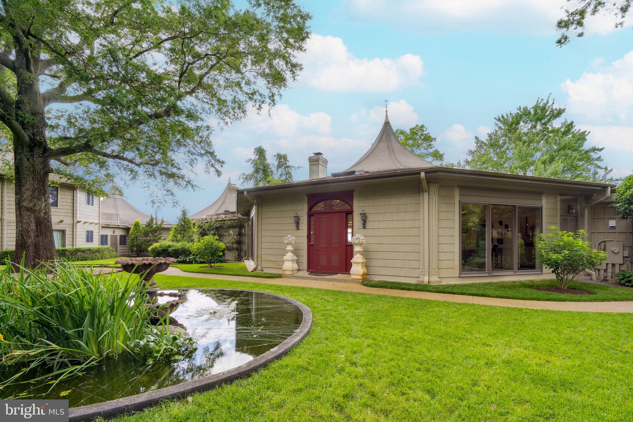 9791 Pintail Place St. Michaels, MD 21663 - Photo 4 of 80 a view of a house with a yard potted plants and large tree