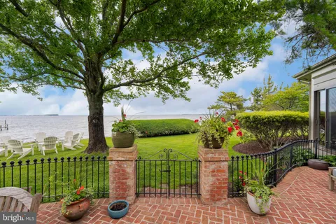 a view of a patio with table and chairs and potted plants