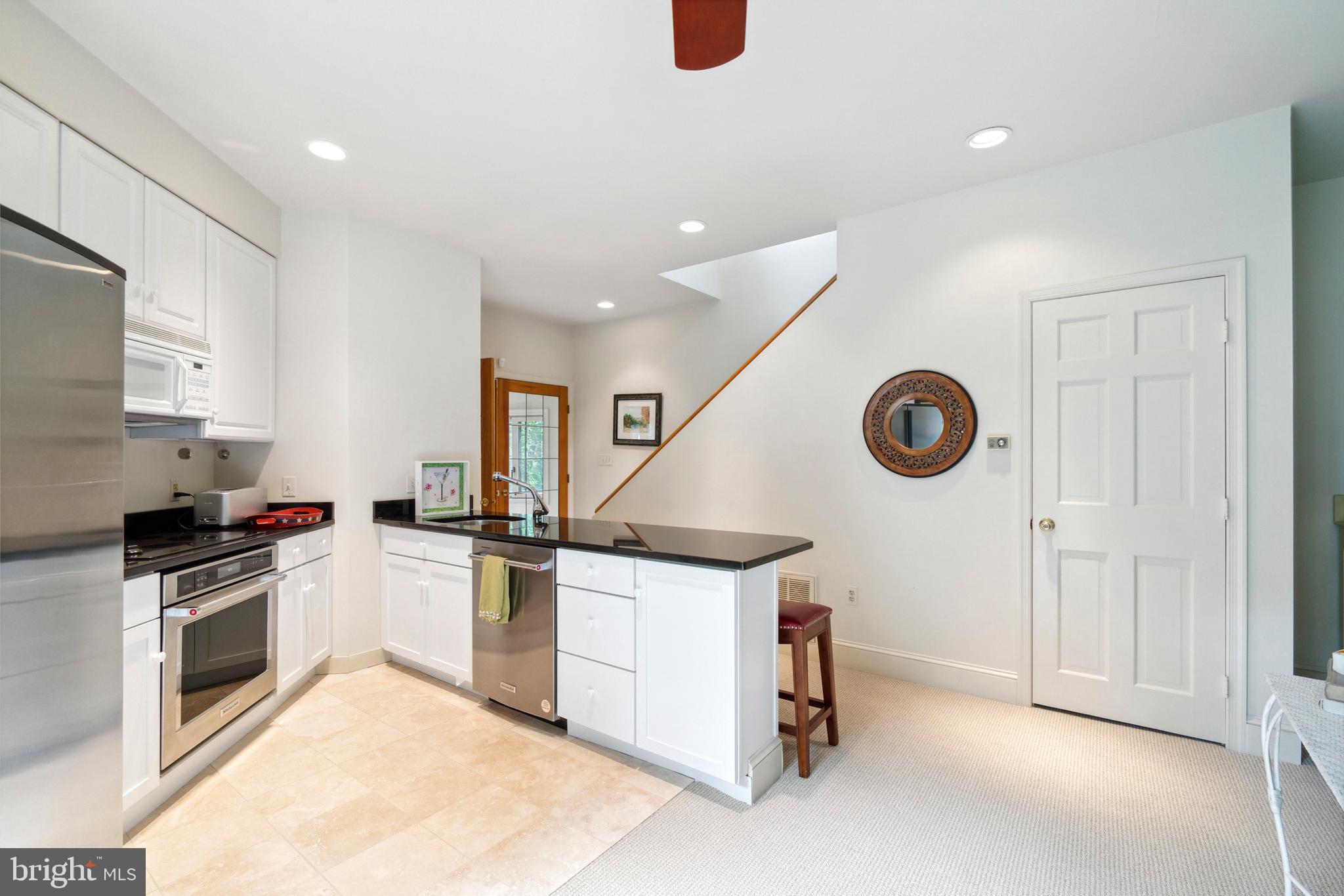 9791 Pintail Place St. Michaels, MD 21663 - Photo 46 of 80 a kitchen with a stove and a microwave