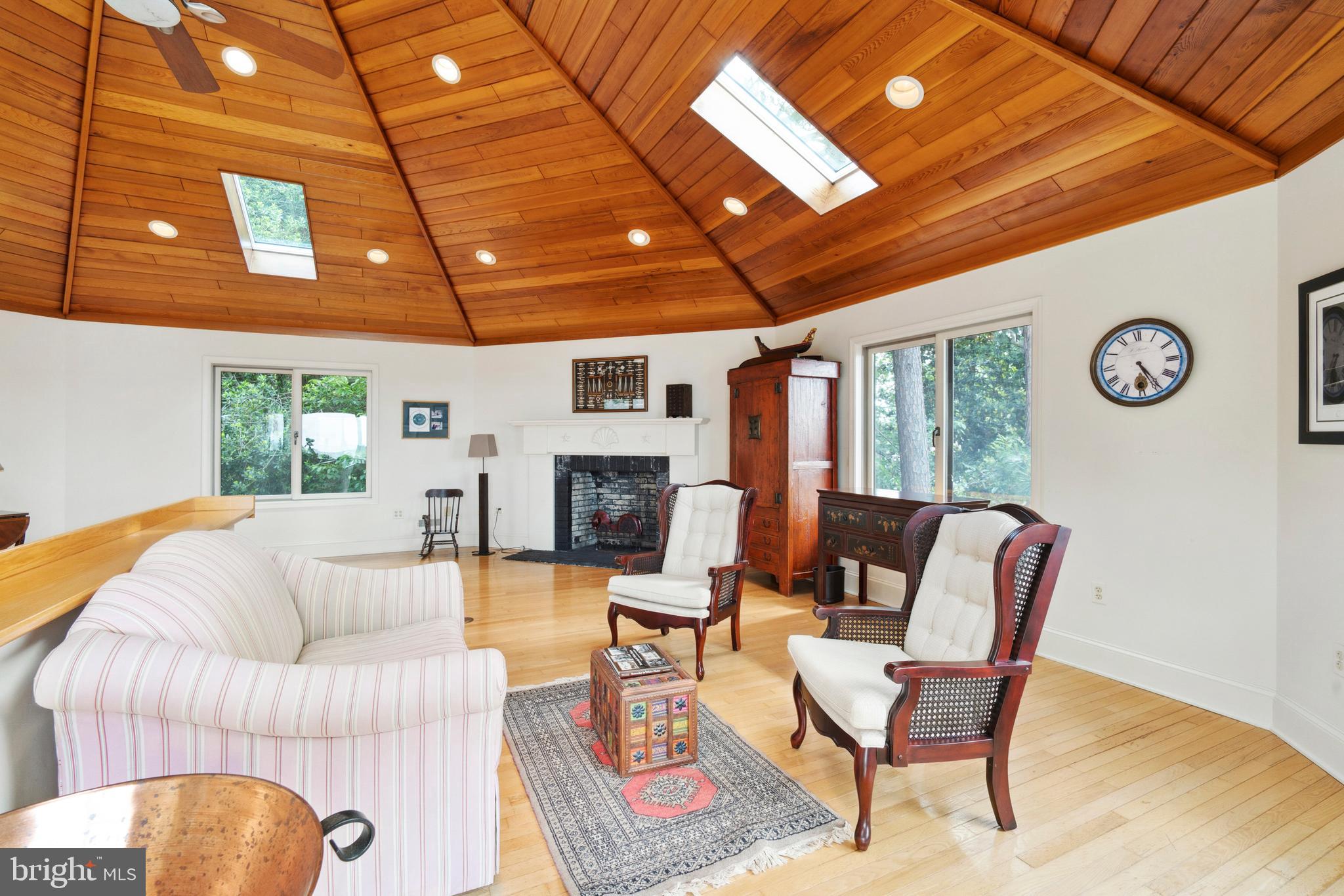 9791 Pintail Place St. Michaels, MD 21663 - Photo 49 of 80 a living room with furniture a fireplace and a flat screen tv