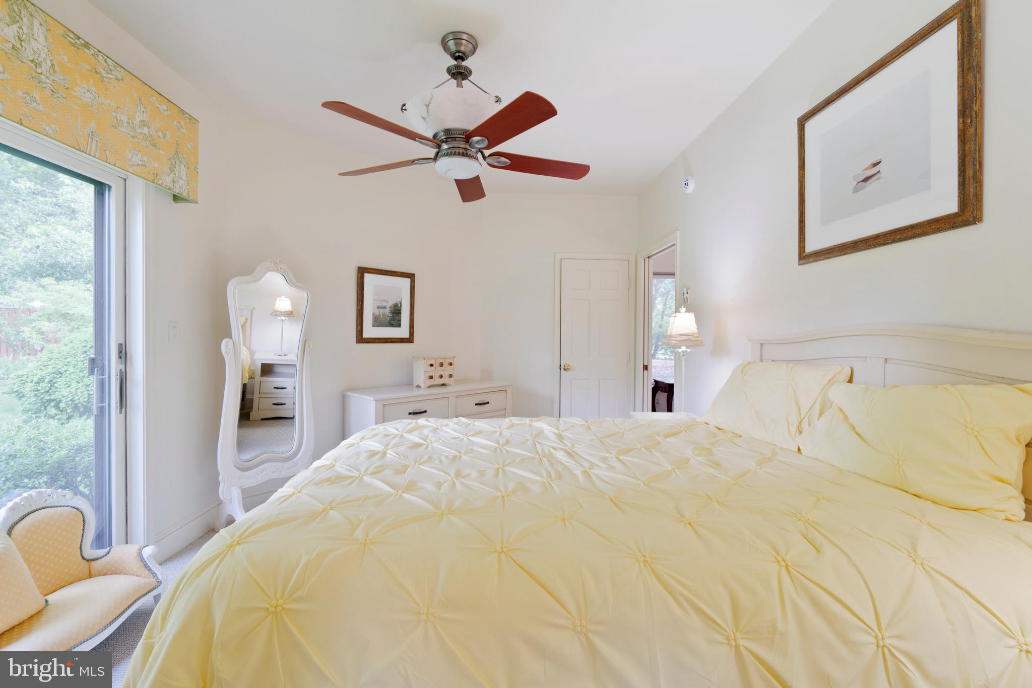 9791 Pintail Place St. Michaels, MD 21663 - Photo 52 of 80 a bedroom with a bed and a chandelier