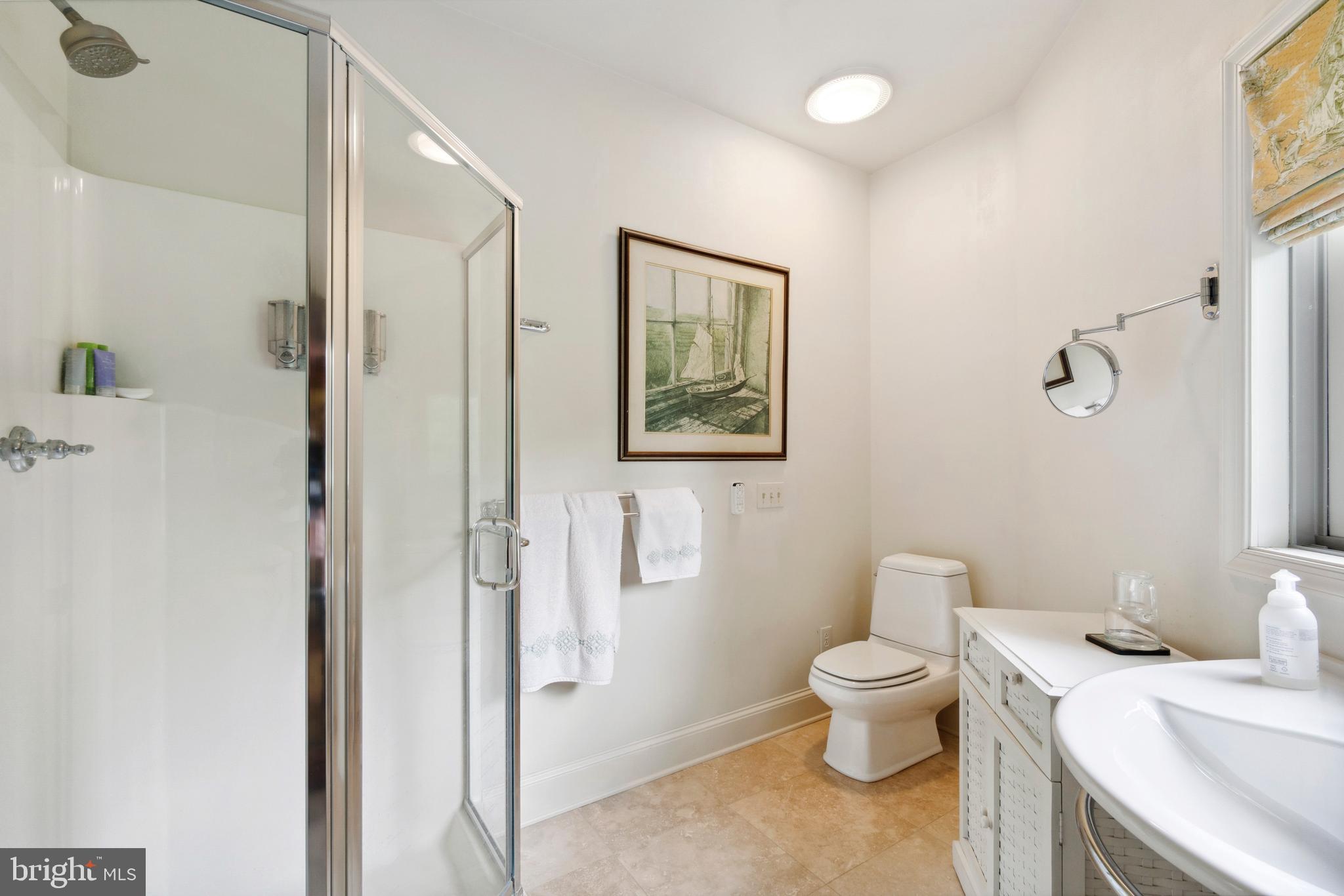9791 Pintail Place St. Michaels, MD 21663 - Photo 53 of 80 a bathroom with a toilet sink and a mirror