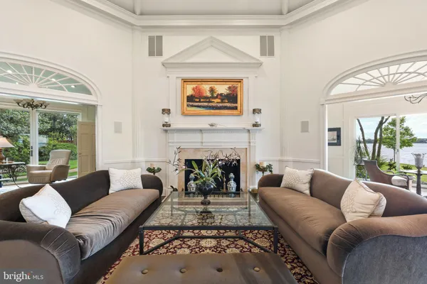 a living room with patio furniture and a floor to ceiling window