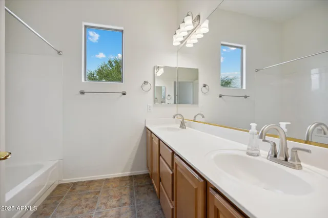 a bathroom with a double vanity sink a and a mirror