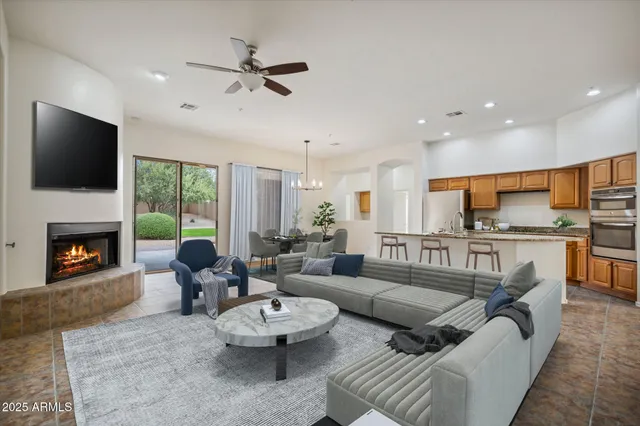 a living room with furniture kitchen view and a fireplace