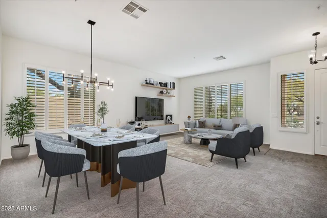 a living room with furniture a window and a flat screen tv