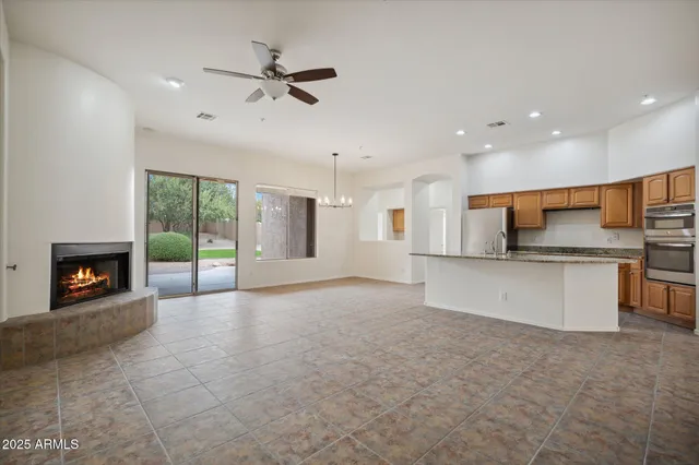 a view of kitchen with a sink and a fireplace