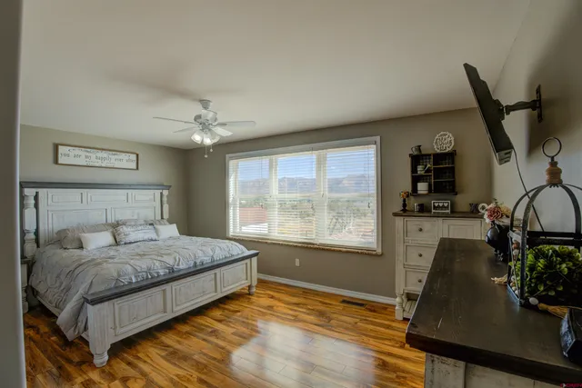 a bedroom with a bed window and flowerpot