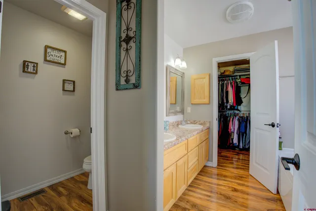 a white toilet sitting next to a bathroom sink