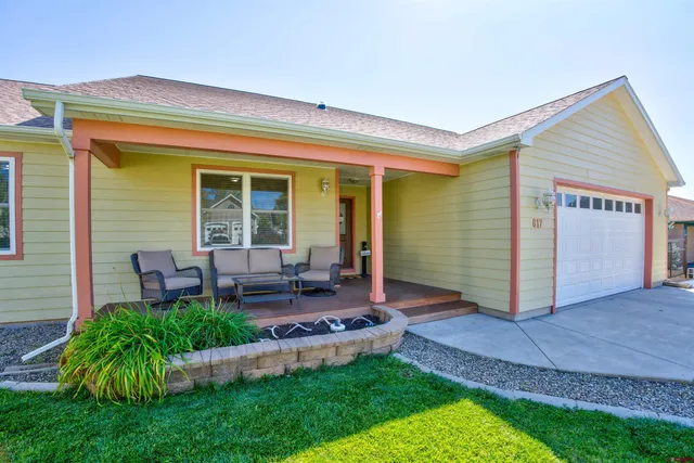 a view of an house with backyard porch and sitting area