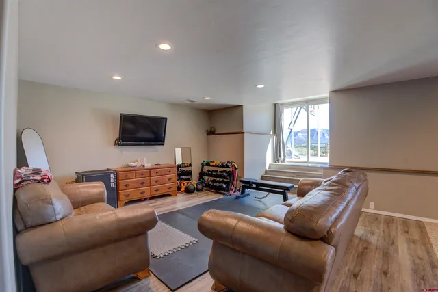 a view of a room with gym equipment and a chandelier