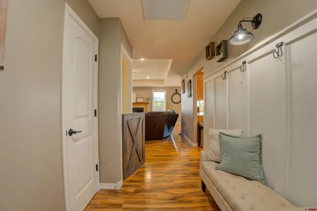a hallway with a couch and wooden floor