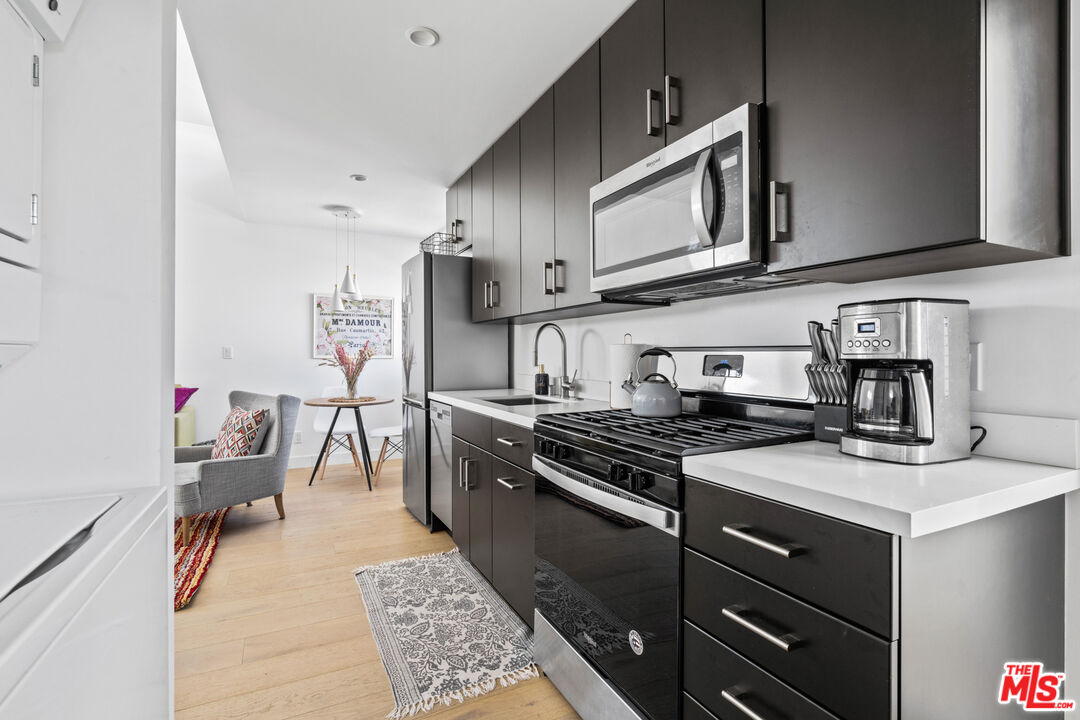 823 Flower Avenue Venice, CA 90291 - Photo 11 of 17 a kitchen with stainless steel appliances granite countertop a stove and a sink