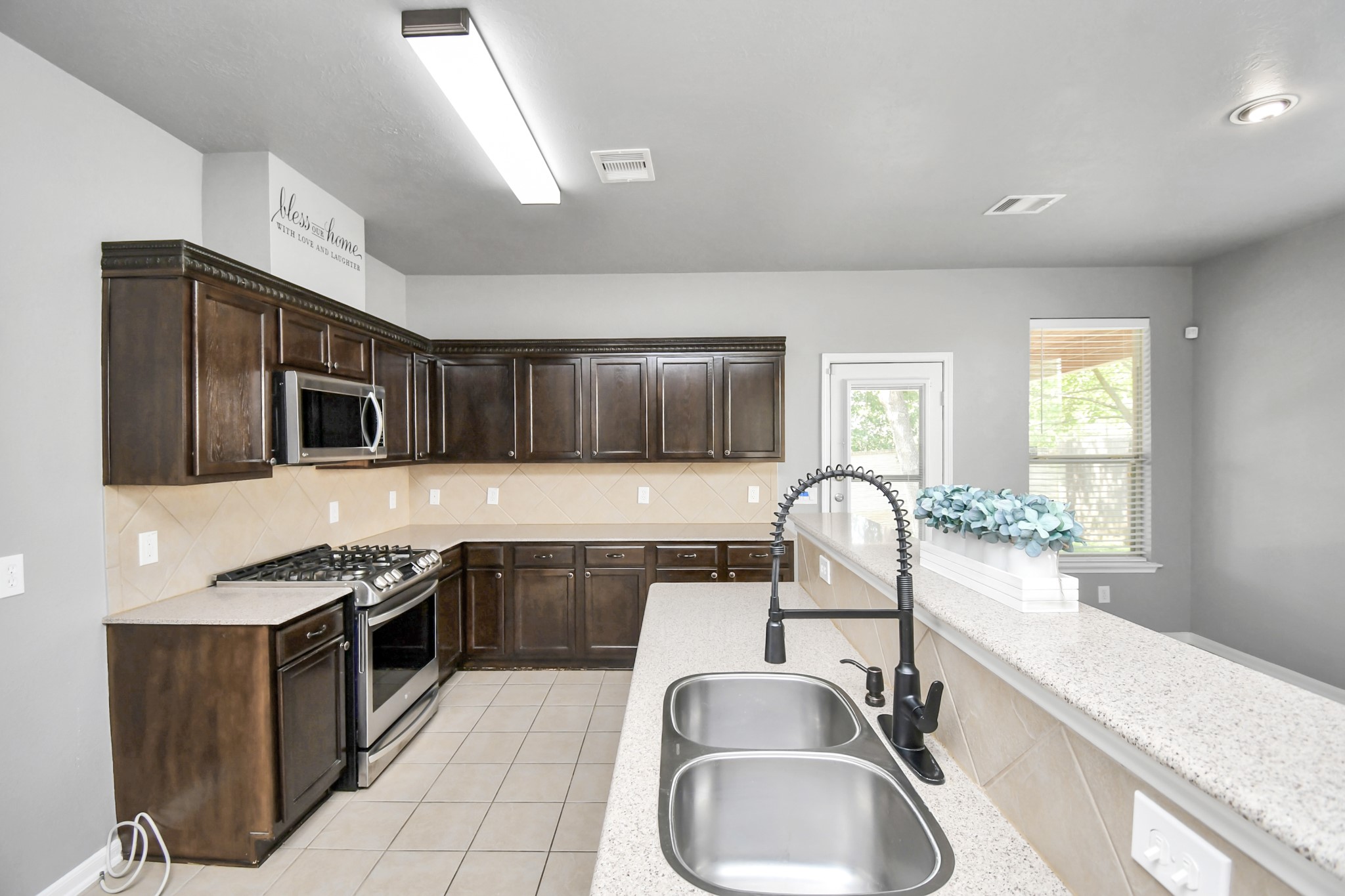 2808 Tranquility Trail Pearland, TX 77584 - Photo 7 of 30 a kitchen with stainless steel appliances granite countertop a sink stove and refrigerator