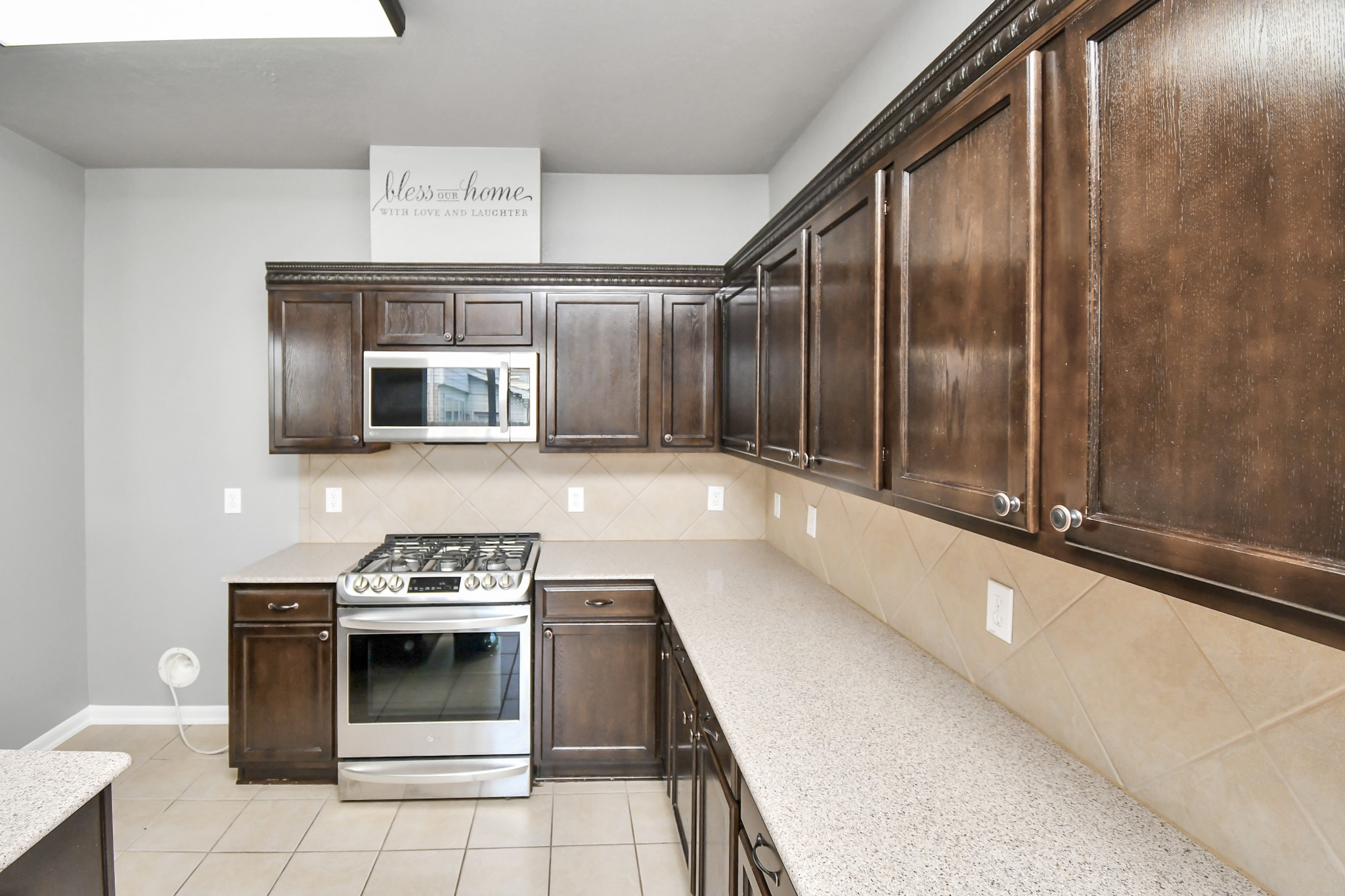 2808 Tranquility Trail Pearland, TX 77584 - Photo 9 of 30 a kitchen with a stove and a microwave
