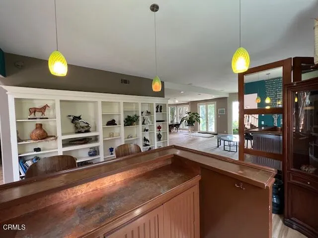 a kitchen with cabinets and outdoor space