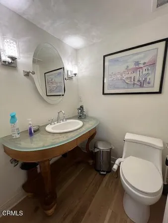 a bathroom with a toilet a sink and mirror