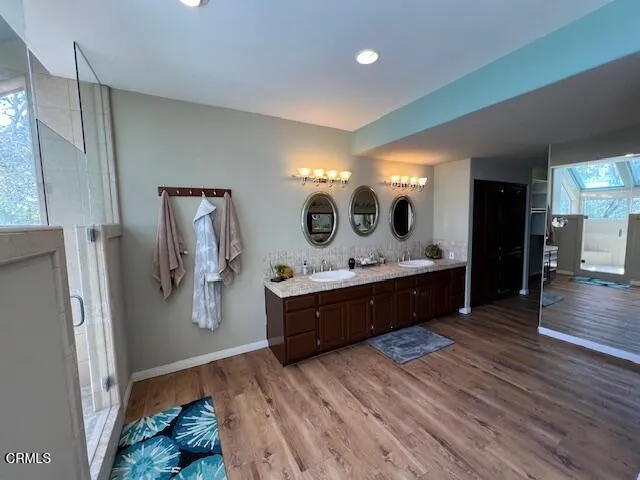a spacious bathroom with a tub sink and mirror