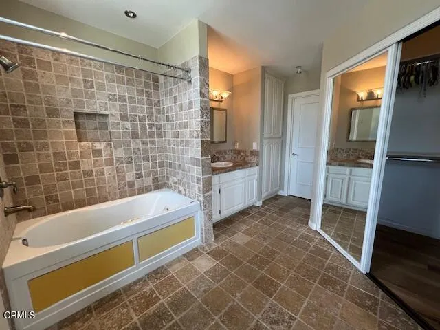 a bathroom with a bathtub and a shower