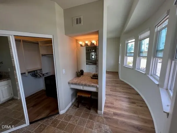 a room with wooden floor and a balcony