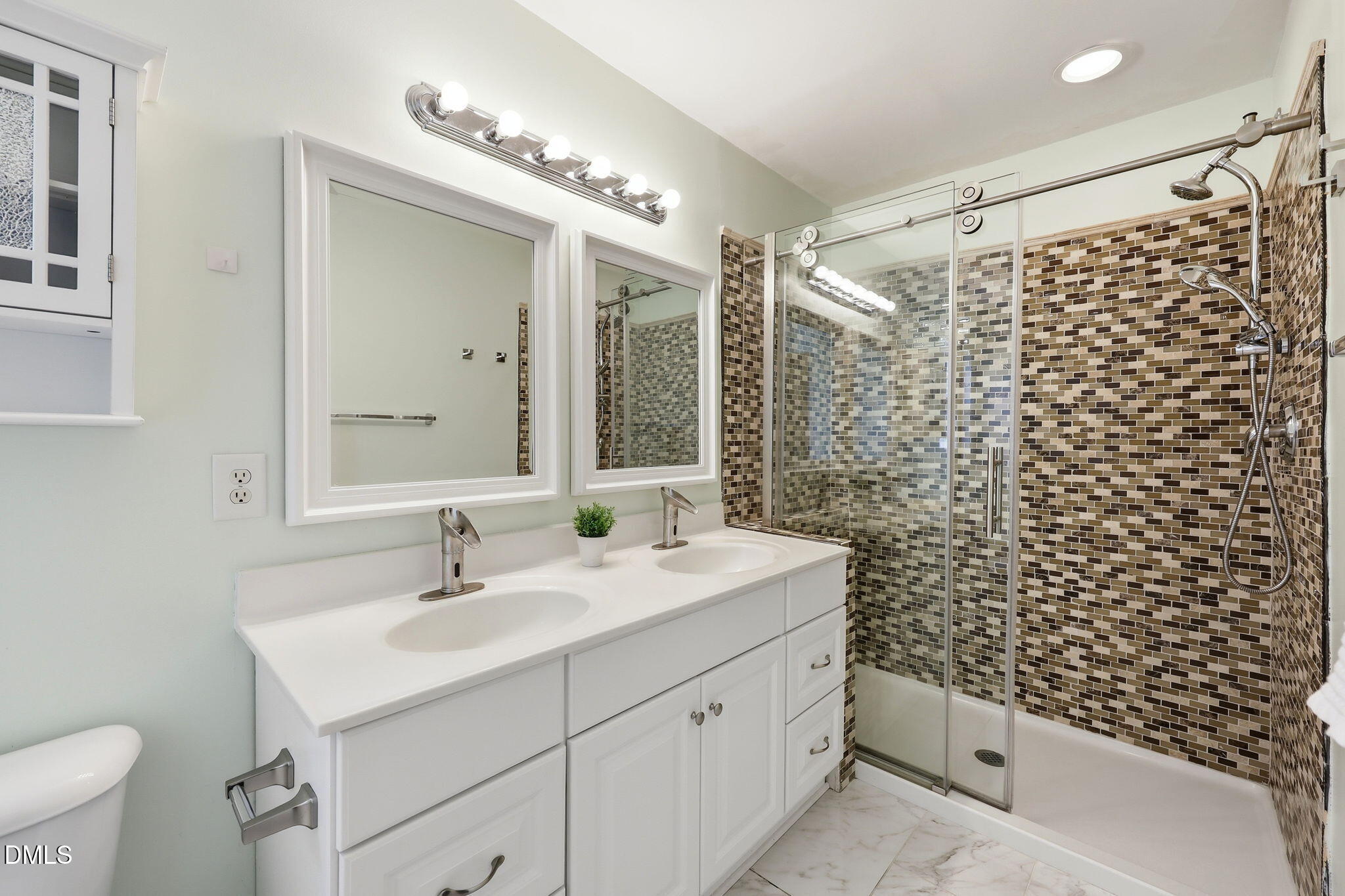4232 Dalcross Road Raleigh, NC 27610 - Photo 20 of 42 a bathroom with a sink a toilet a mirror and shower