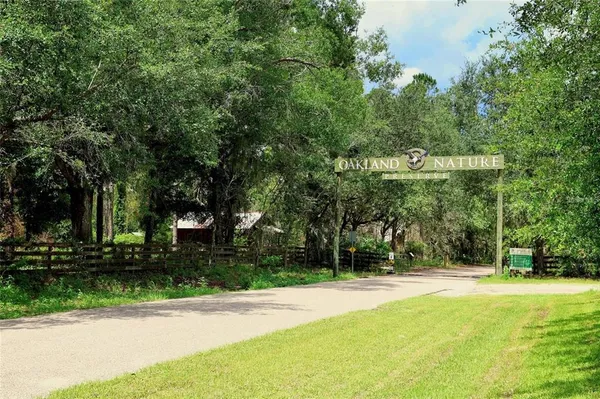 a view of a yard with a house and large trees