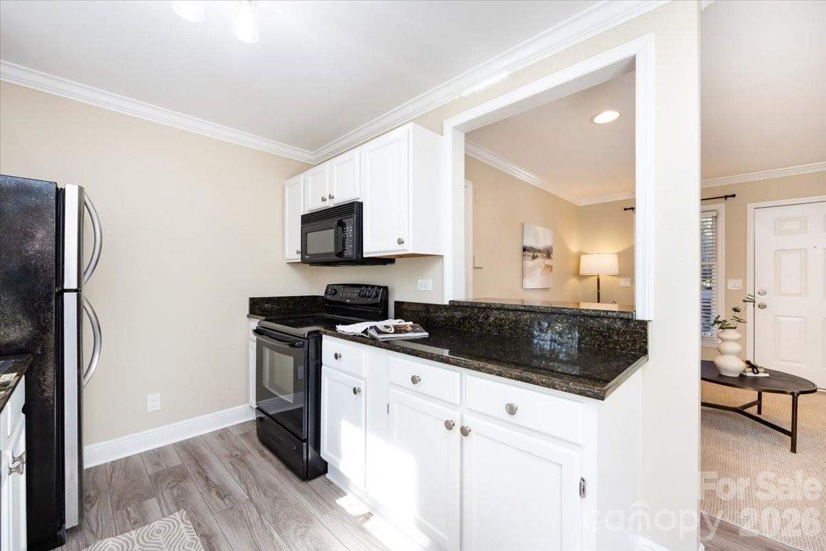 430 Queens Road, Unit 221 Charlotte, NC 28207 - Photo 11 of 21 a kitchen with a sink stove and refrigerator