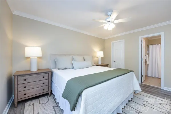 a spacious bedroom with a bed and a lamp