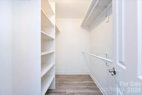 a view of walk in closet with empty racks