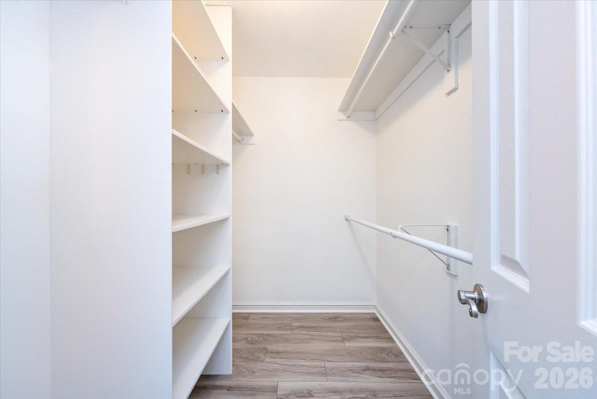 430 Queens Road, Unit 221 Charlotte, NC 28207 - Photo 14 of 21 a view of walk in closet with empty racks