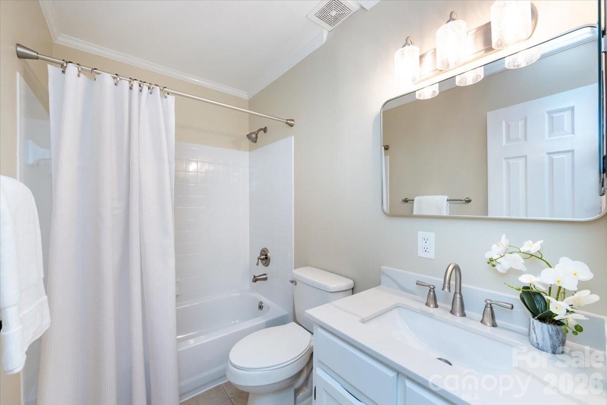 430 Queens Road, Unit 221 Charlotte, NC 28207 - Photo 15 of 21 a bathroom with a granite countertop sink a toilet and shower